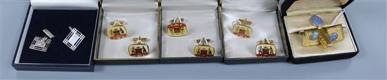 A pair of pierced silver cufflinks and four other pairs of metal cufflinks including opal pair with tie clip.